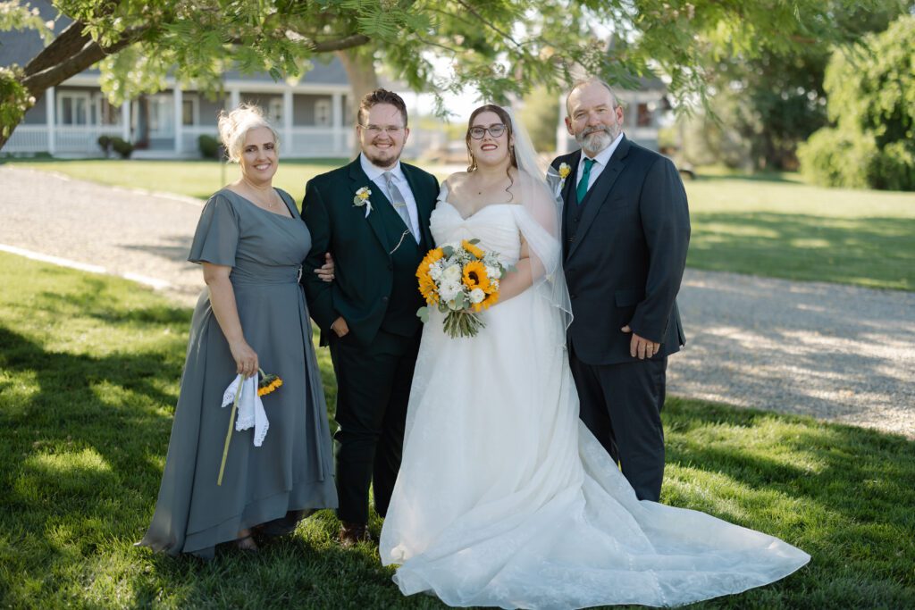 Bride and Groom posing with parents during their Colorado wedding family photos
